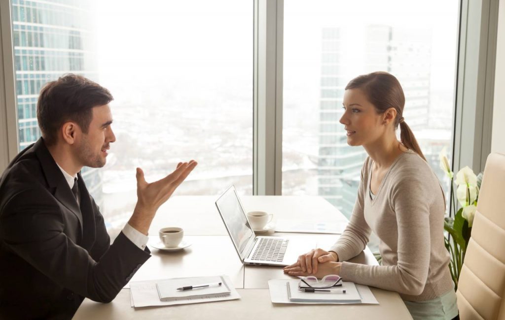 businessman-businesswoman-discussing-work-office-desk
